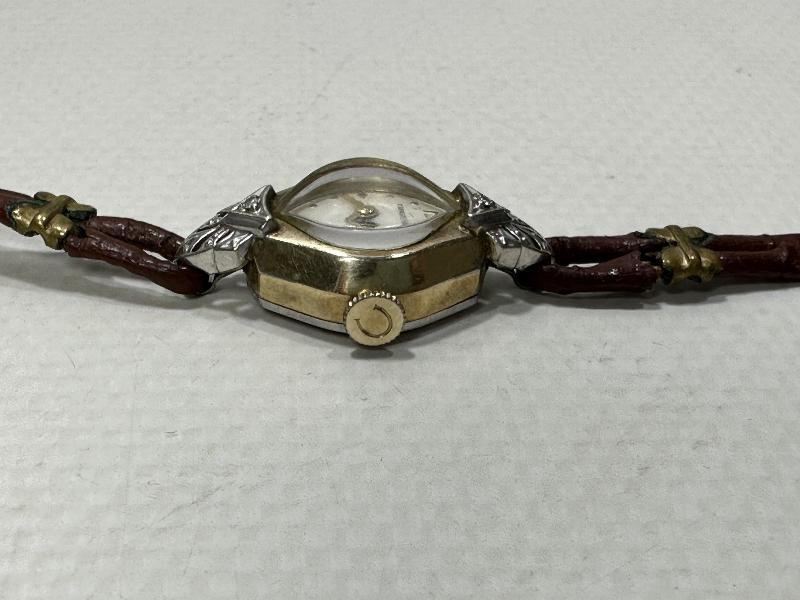 ANTİKA CARAVELLE MARKA ALTIN KAPLAMA KURMALI BAYAN KOL SAATİ 