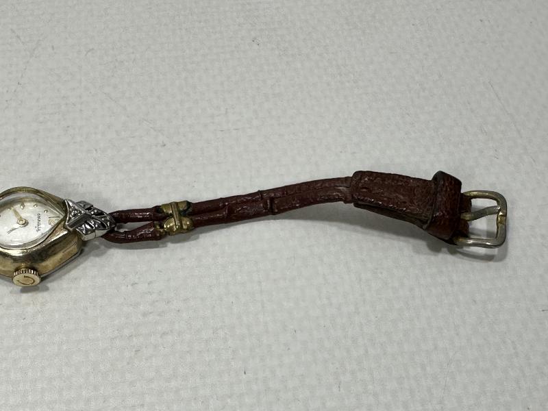 ANTİKA CARAVELLE MARKA ALTIN KAPLAMA KURMALI BAYAN KOL SAATİ 