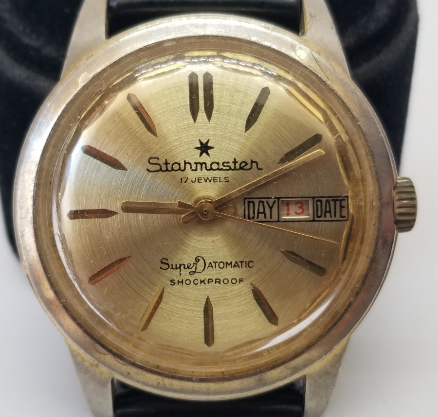 STARMASTER MARKA ALTIN KAPLAMA KURMALI VE TAKVİMLİ KOL SAATİ