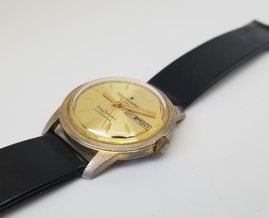 STARMASTER MARKA ALTIN KAPLAMA KURMALI VE TAKVİMLİ KOL SAATİ