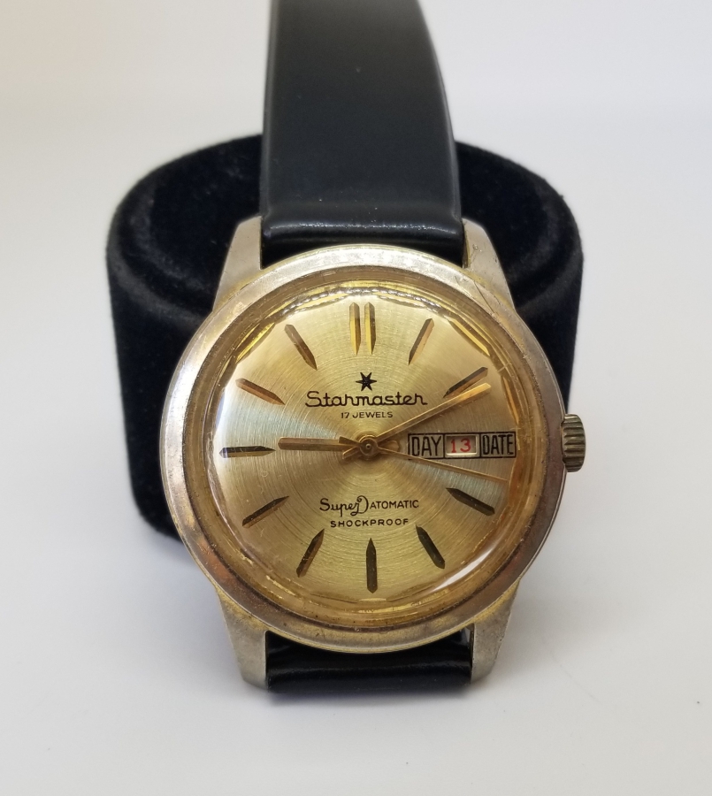 STARMASTER MARKA ALTIN KAPLAMA KURMALI VE TAKVİMLİ KOL SAATİ